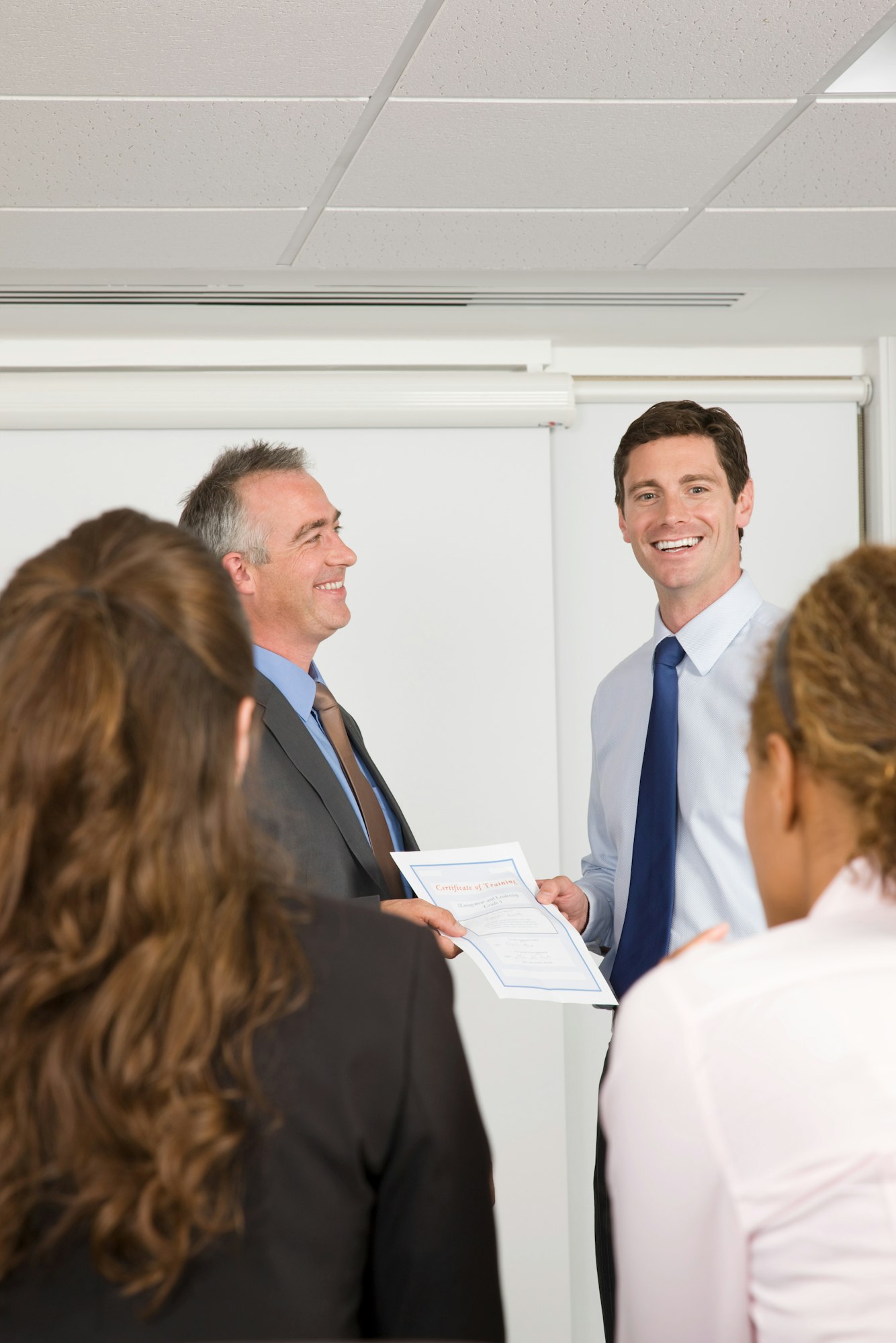 A lecturer handing a certificate to a student